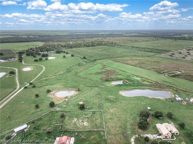 birds eye view of property with a rural view