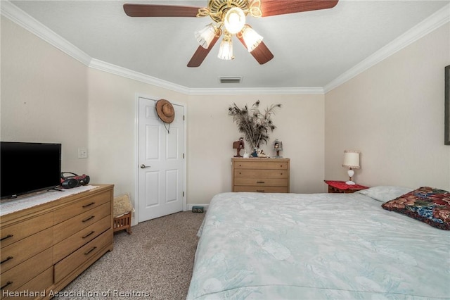 carpeted bedroom with ceiling fan and ornamental molding