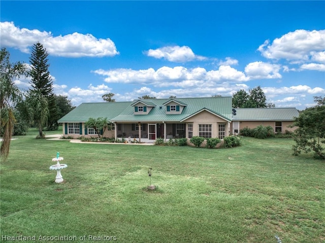 view of front of property with a front yard and a sunroom