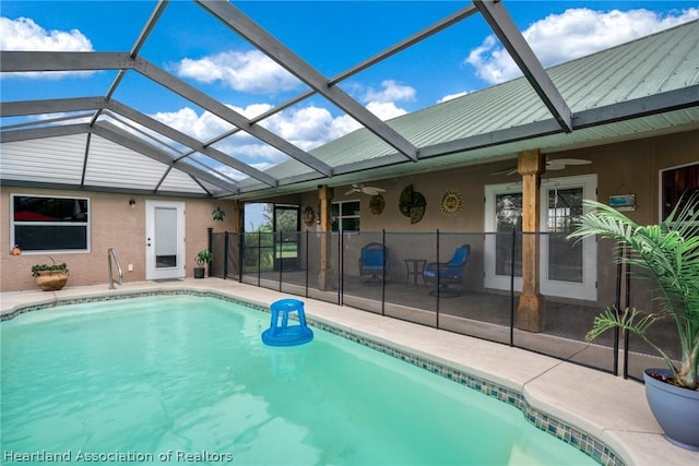 view of swimming pool with a patio area, ceiling fan, and a lanai