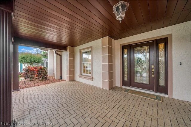 property entrance with stucco siding