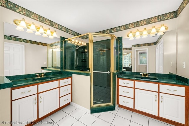 full bathroom featuring tile patterned floors, two vanities, a shower stall, and a sink