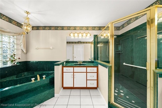 full bathroom with a stall shower, a garden tub, tile patterned flooring, and vanity