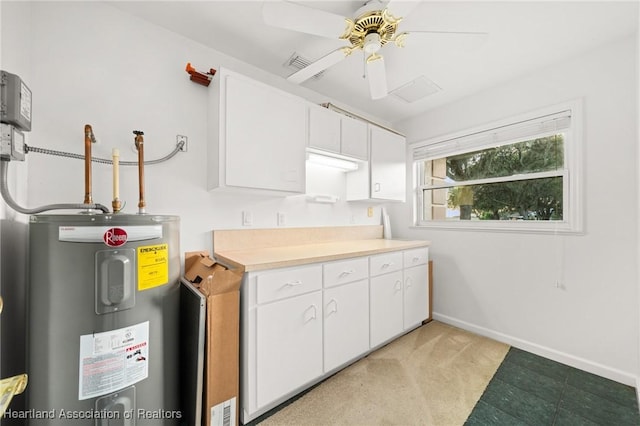 kitchen featuring electric water heater, light countertops, white cabinets, baseboards, and a ceiling fan