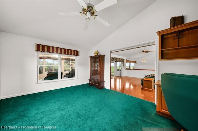 unfurnished living room featuring high vaulted ceiling, ceiling fan, and carpet flooring