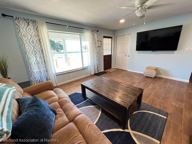 living room featuring ceiling fan and wood-type flooring