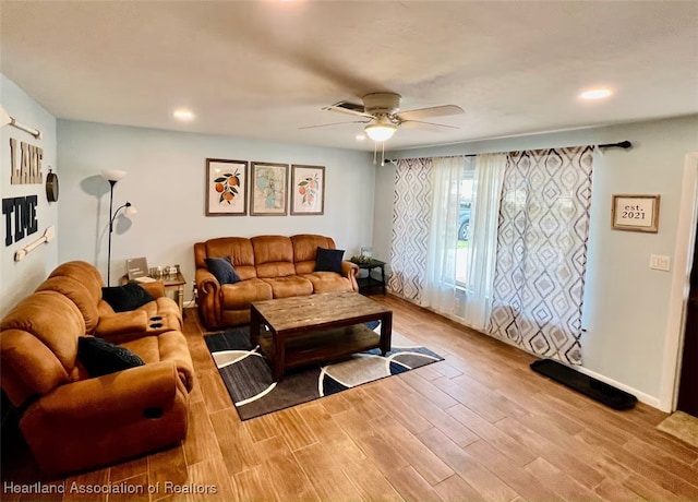 living room with light wood finished floors, ceiling fan, baseboards, and recessed lighting