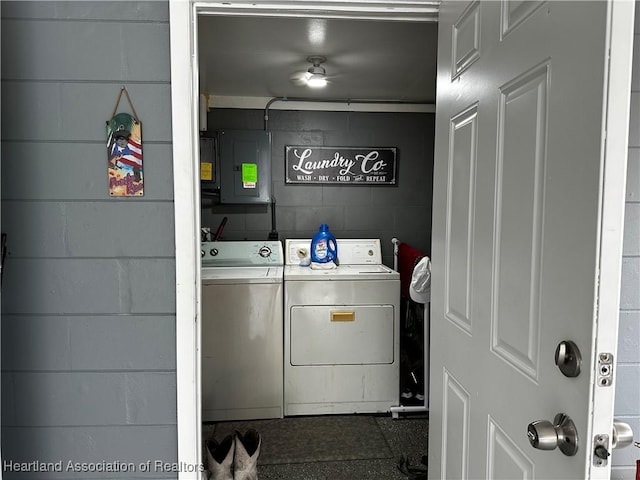 laundry area with independent washer and dryer and electric panel