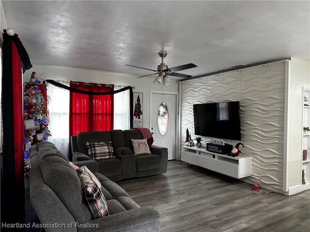 living room featuring wood-type flooring and ceiling fan