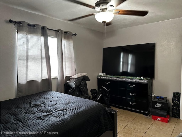 bedroom with ceiling fan and light tile patterned flooring