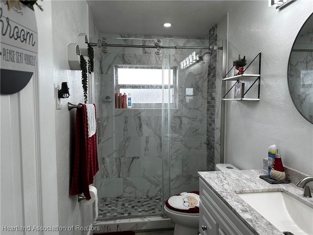 bathroom featuring vanity, toilet, and walk in shower