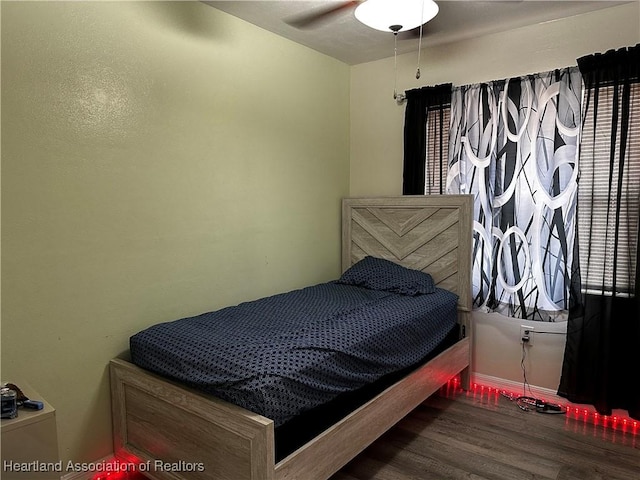 bedroom with ceiling fan and wood-type flooring