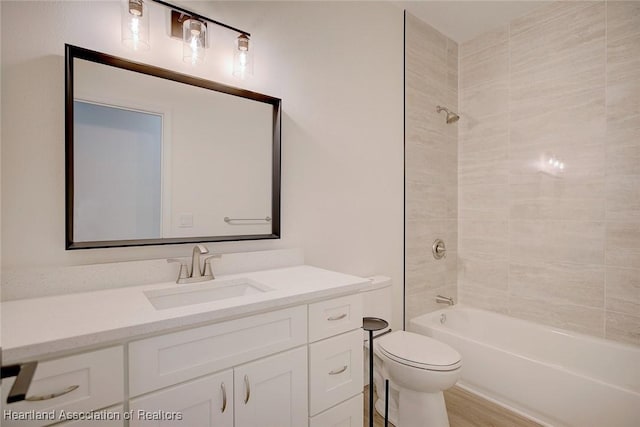 bathroom with vanity, shower / tub combination, toilet, and wood finished floors