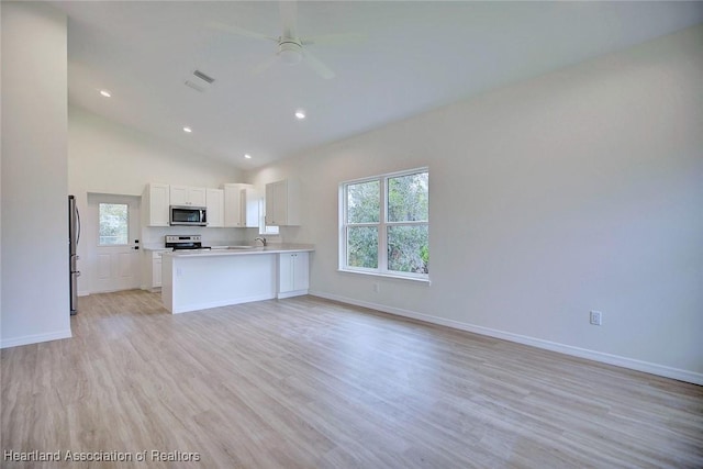 kitchen with visible vents, light wood-type flooring, appliances with stainless steel finishes, white cabinetry, and open floor plan