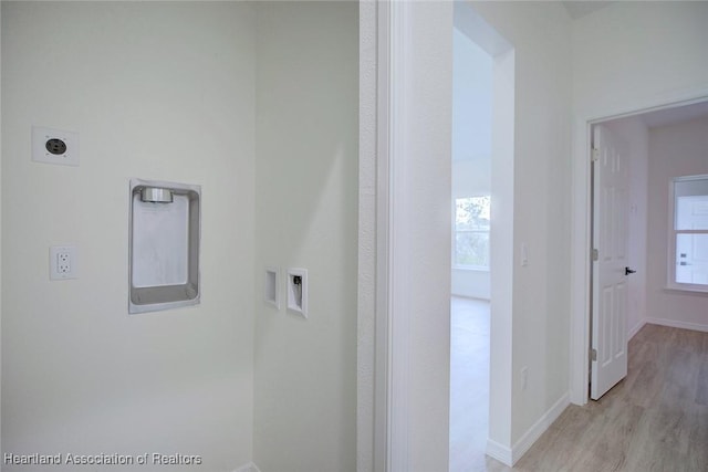 hall featuring light wood finished floors and baseboards