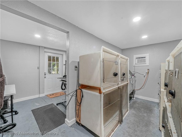 1954 Heard Rd, Wauchula, FL 33873 - misc room featuring a wall mounted air conditioner, recessed lighting, concrete floors, and baseboards