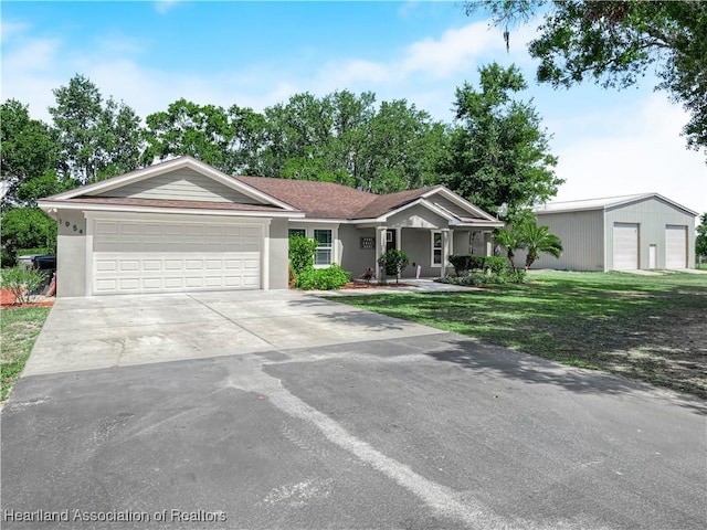 1954 Heard Rd, Wauchula, FL 33873 - ranch-style home with stucco siding, a front lawn, concrete driveway, and an attached garage