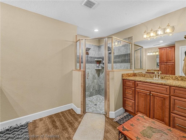 1954 Heard Rd, Wauchula, FL 33873 - full bath with baseboards, visible vents, wood finished floors, and a shower stall