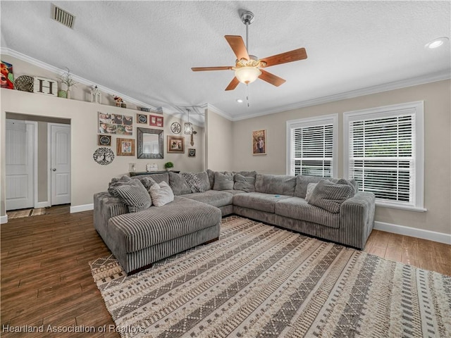 1954 Heard Rd, Wauchula, FL 33873 - living area featuring a textured ceiling, crown molding, baseboards, wood finished floors, and a ceiling fan