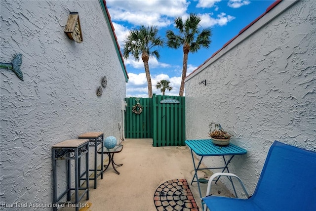 view of patio featuring a gate