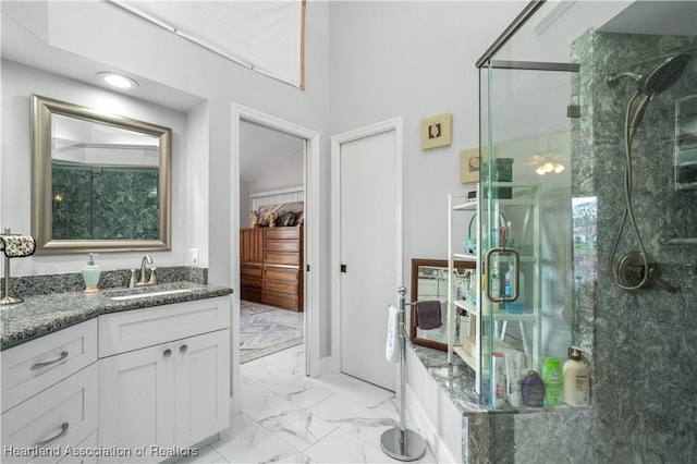 full bath with marble finish floor, a stall shower, and vanity