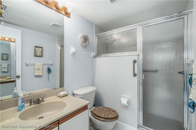 bathroom with visible vents, a shower stall, toilet, and vanity