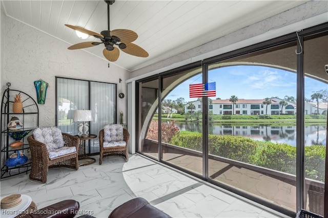 sunroom featuring a water view, ceiling fan, wood ceiling, and lofted ceiling