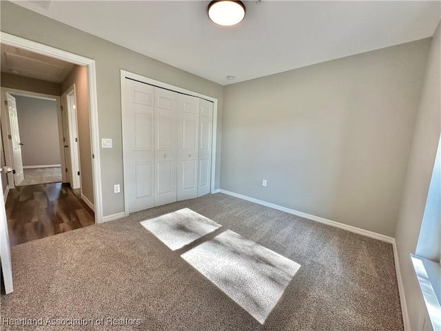 unfurnished bedroom with carpet floors and a closet