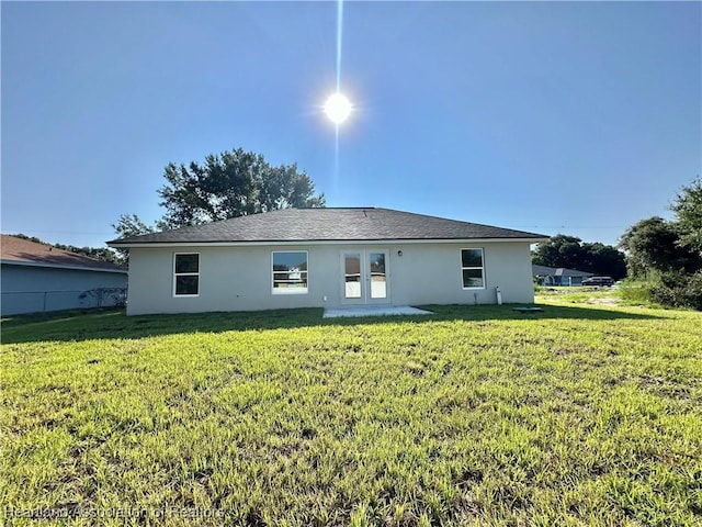 back of property with a lawn