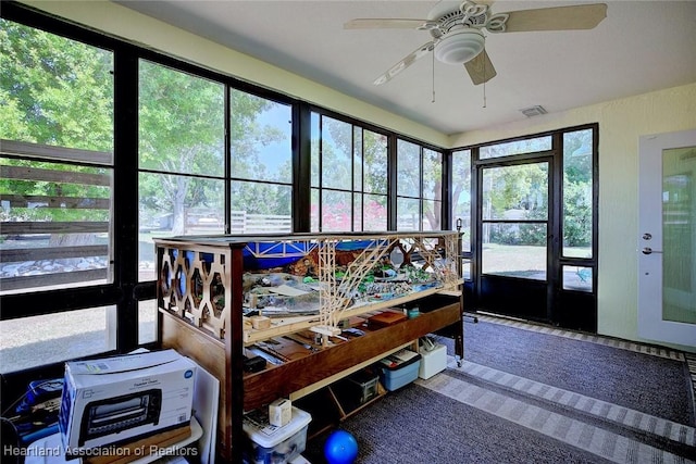 sunroom / solarium featuring visible vents and ceiling fan