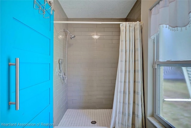 bathroom featuring a shower stall and a textured ceiling
