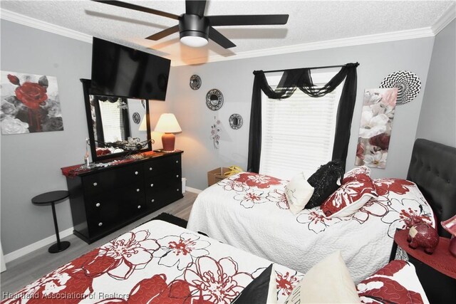 bedroom with baseboards, ceiling fan, wood finished floors, a textured ceiling, and crown molding