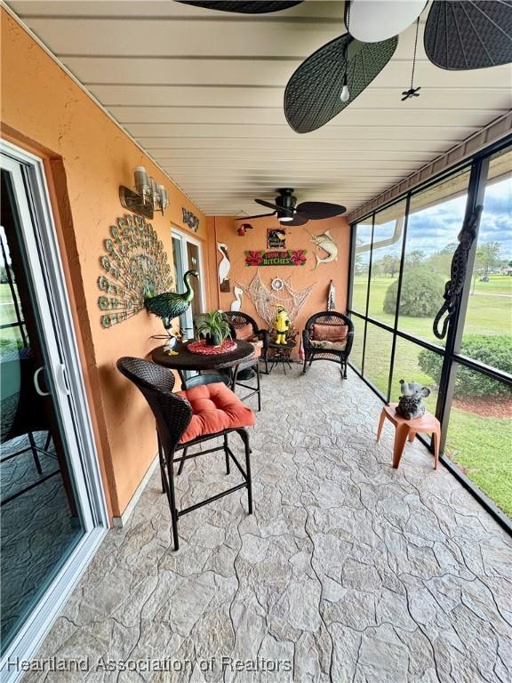 sunroom / solarium with ceiling fan