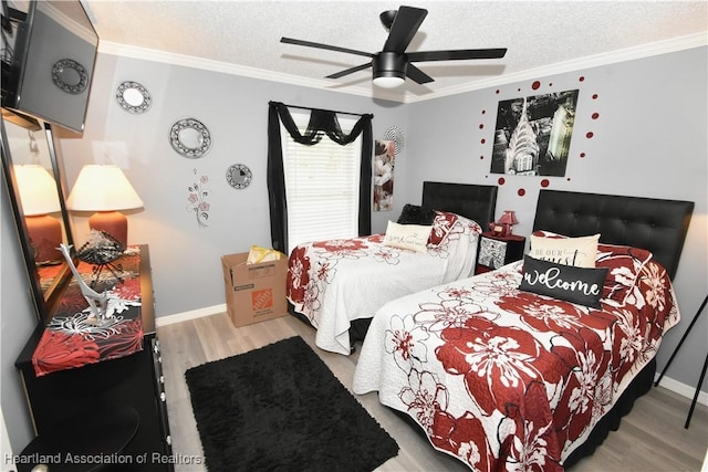 bedroom featuring a textured ceiling, ornamental molding, a ceiling fan, and light wood-style floors