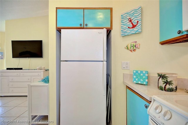4773 Casablanca Cir Unit D22, Sebring, FL 33870 - kitchen with light tile patterned flooring, freestanding refrigerator, and light countertops