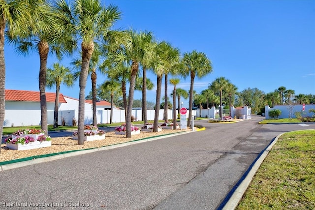 4773 Casablanca Cir Unit D22, Sebring, FL 33870 - view of road featuring curbs, a gated entry, and traffic signs