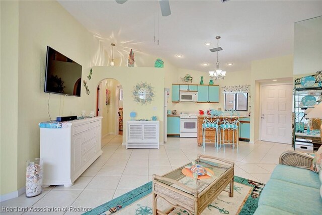 4773 Casablanca Cir Unit D22, Sebring, FL 33870 - living area featuring light tile patterned flooring, recessed lighting, ceiling fan with notable chandelier, and arched walkways