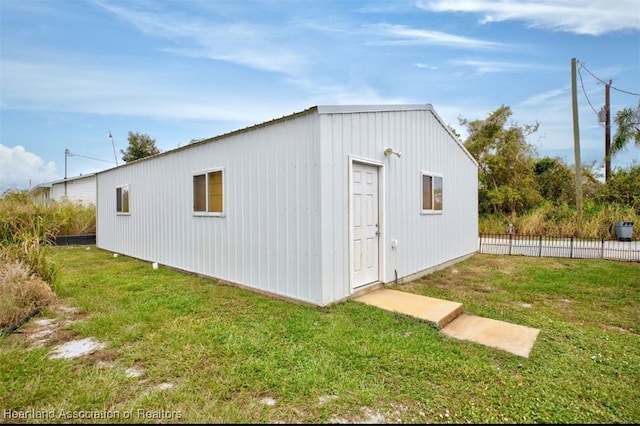 view of outbuilding featuring a yard