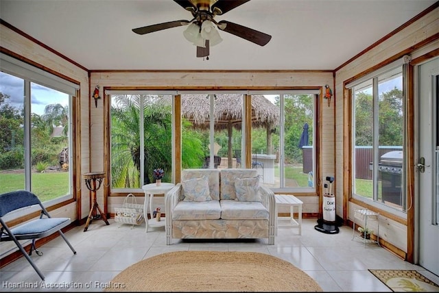 unfurnished sunroom featuring ceiling fan