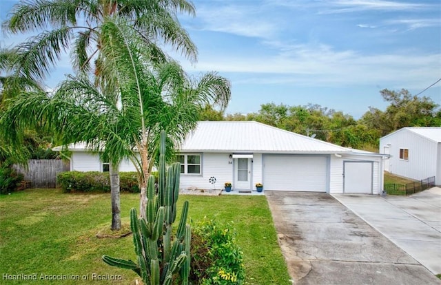 ranch-style house featuring a front yard and a garage