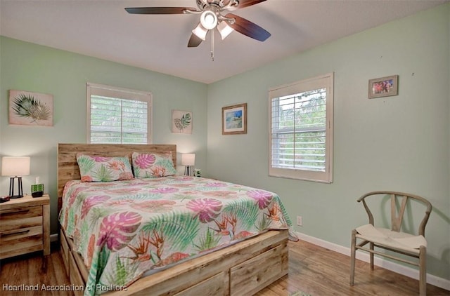 bedroom with hardwood / wood-style floors and ceiling fan