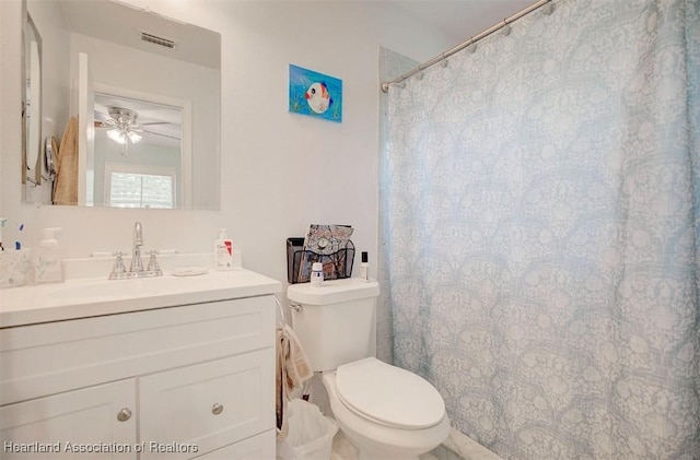 bathroom featuring vanity, toilet, and ceiling fan