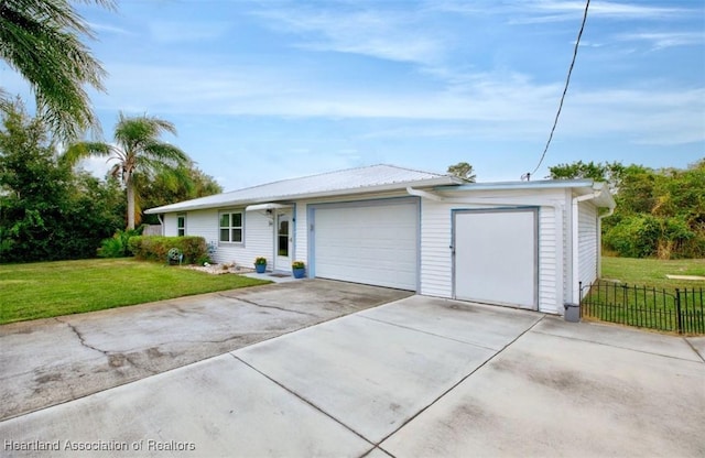 single story home featuring a front yard and a garage