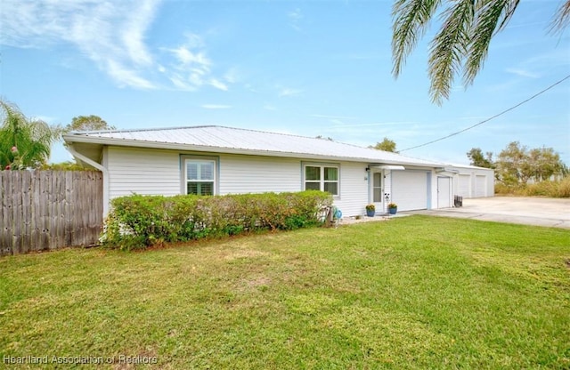 ranch-style home with a garage and a front yard