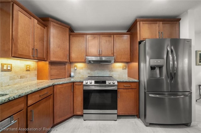 1904 Mulligan Rd, Sebring, FL 33872 - kitchen featuring appliances with stainless steel finishes, under cabinet range hood, brown cabinetry, and light stone countertops