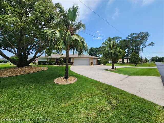 1904 Mulligan Rd, Sebring, FL 33872 - ranch-style house with driveway, a front yard, and an attached garage