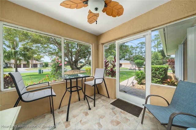 1904 Mulligan Rd, Sebring, FL 33872 - sunroom featuring stone finish flooring, ceiling fan, and a textured wall
