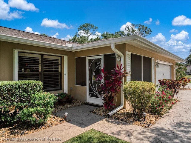 1904 Mulligan Rd, Sebring, FL 33872 - entrance to property with an attached garage and stucco siding