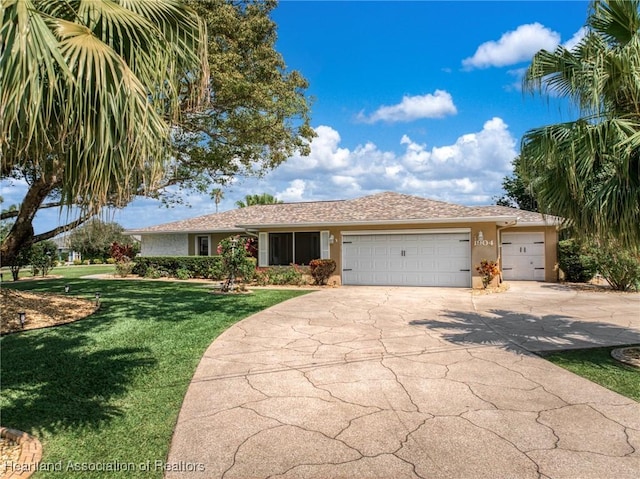 1904 Mulligan Rd, Sebring, FL 33872 - view of front of home with a garage, a front yard, concrete driveway, and stucco siding