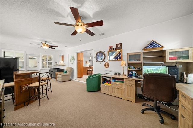 1904 Mulligan Rd, Sebring, FL 33872 - office area featuring light carpet, a ceiling fan, a textured ceiling, and built in desk